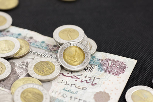 istock Egyptian Pound Laying on a Hundred Pound Banknote 637800716