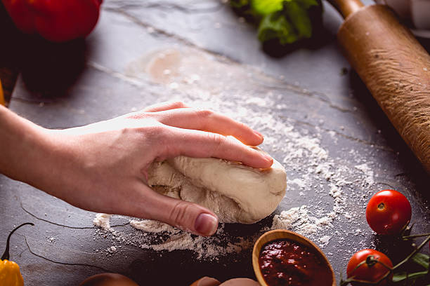 istock Young girl's hand knead the dough 637800914