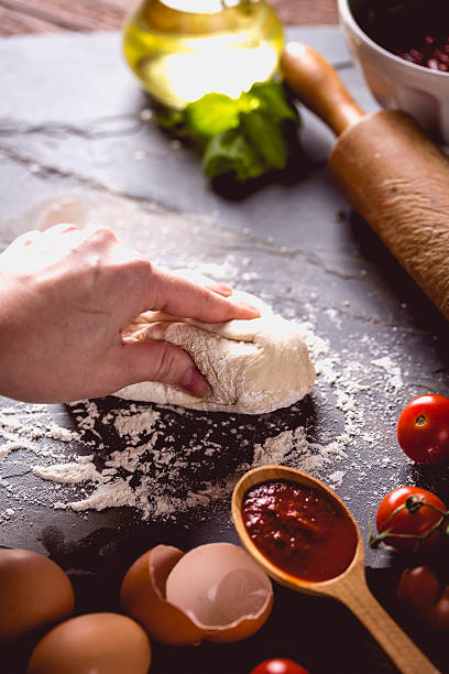 istock Young girl's hand knead the dough 637801328