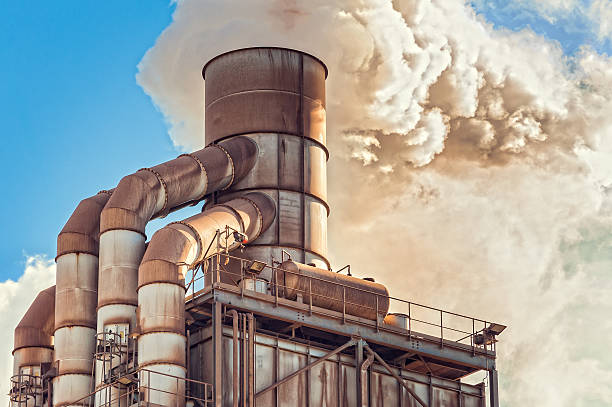 istock Old smokestack that emits smoke. 637801394