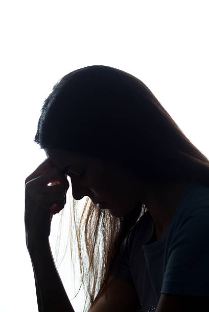 istock Silhouette of a young woman keep her head 637801828