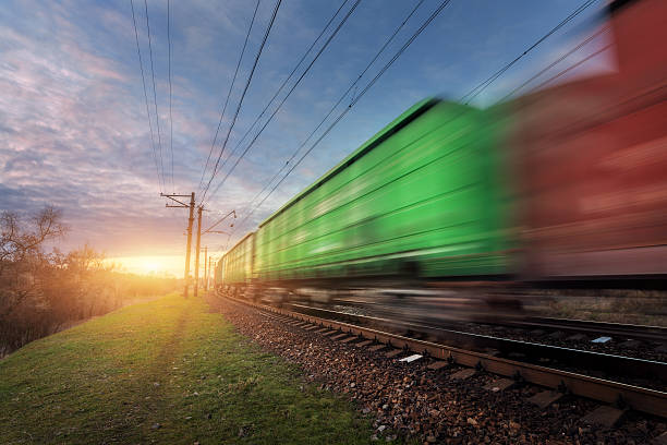 istock Railway station with cargo wagons in motion at sunset 637803408