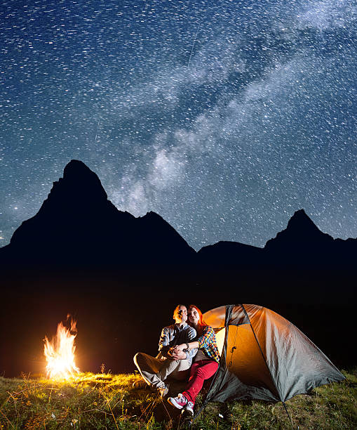 istock Young couple tourists looking to the starry sky 637803626