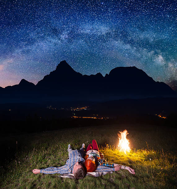 istock tourists lying under incredibly beautiful starry sky 637803928