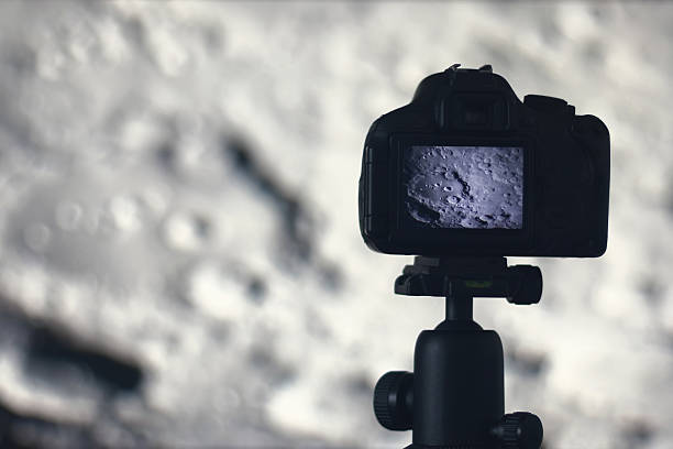 istock Moon photography. Camera with tripod capturing moon. Moon crater Clavius. 637804338