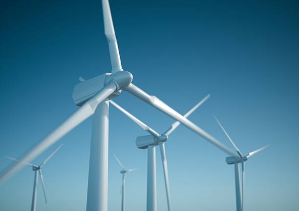 Wind energy turbines White wind turbine generating electricity on blue sky blade stock pictures, royalty-free photos & images