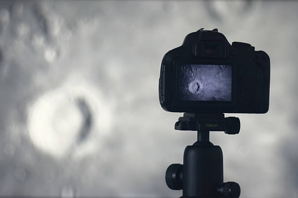 istock Moon photography. Camera with tripod capturing moon. Moon crater Copernicus 637804426