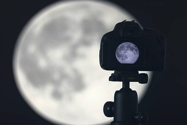 istock Moon photography. Camera with tripod capturing moon. 637804734