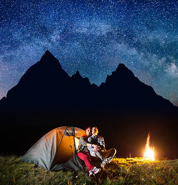 istock Two hikers having a rest in his camp at night 637807550