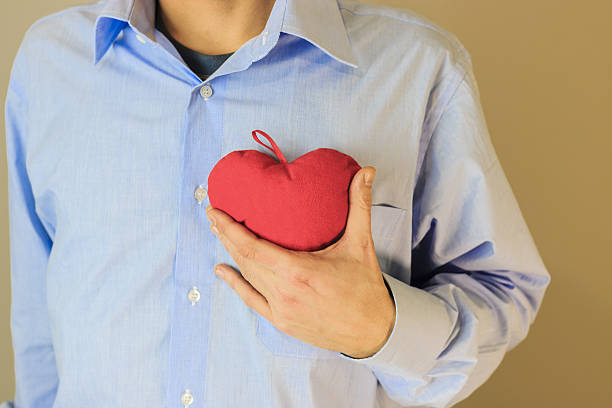 istock Young man holding a heart in his hands 637807674