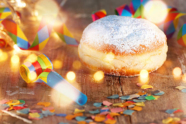 Delicious donuts for carnival Delicious donuts on a wooden table with confetti and bokeh for carnival and party fastnacht stock pictures, royalty-free photos & images