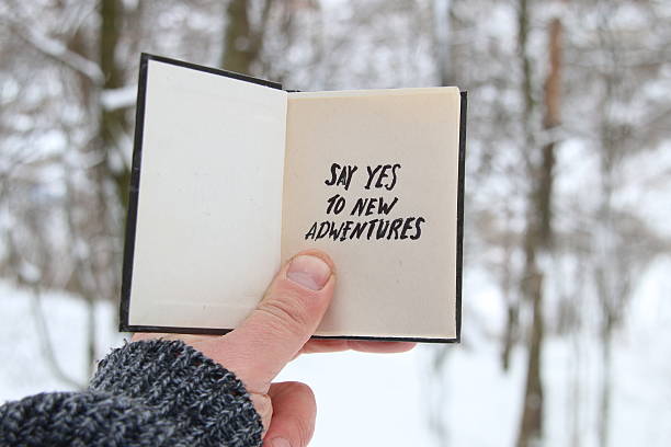 Male holding a book with the inscription Say yes to stock photo