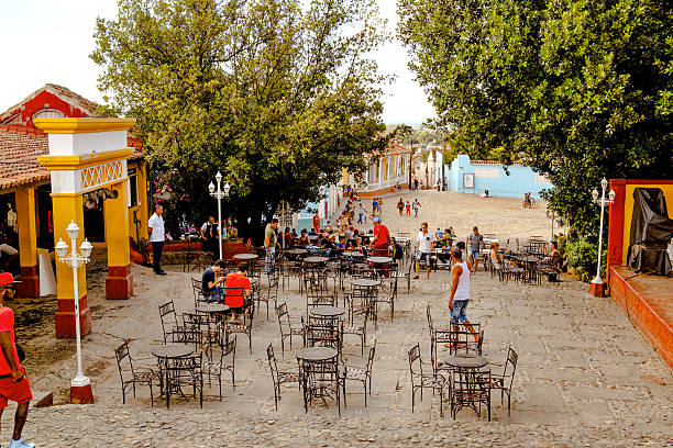 People in the main square of Trinidad, Cuba Trinidad, Cuba - December 18, 2016: People in the main square of the UNESCO World Heritage old town Trinidad, Cuba hemingway house stock pictures, royalty-free photos & images