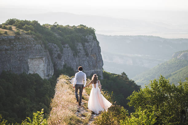 istock Wedding couple walking in the mountains with stunning views 637810484