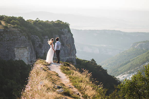 istock Wedding couple walking in the mountains with stunning views 637810666