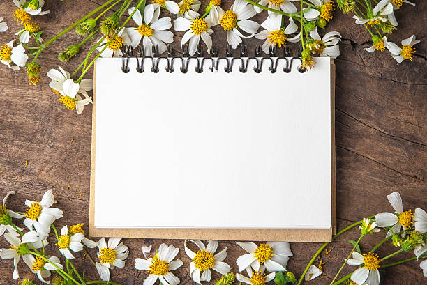 istock Blank notebook with white flower and bas ket of flower 637810836