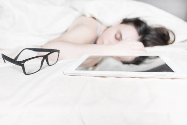 young woman sleeping in the bed with her digital tablet