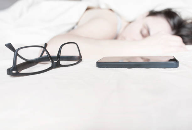 istock Tired young woman sleeping on bed 637811296