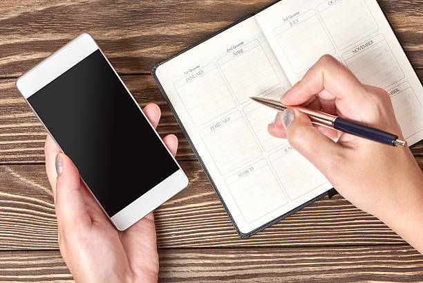 istock Woman hands with a pen and smartphone 637813046