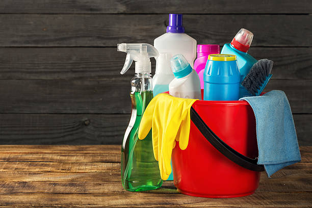 istock Basket with cleaning product on wooden table with copy space 637813154