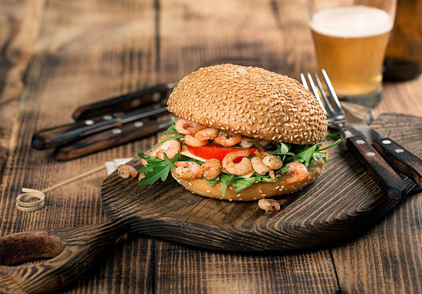 istock Burger with seafood on the old board with lager 637813234
