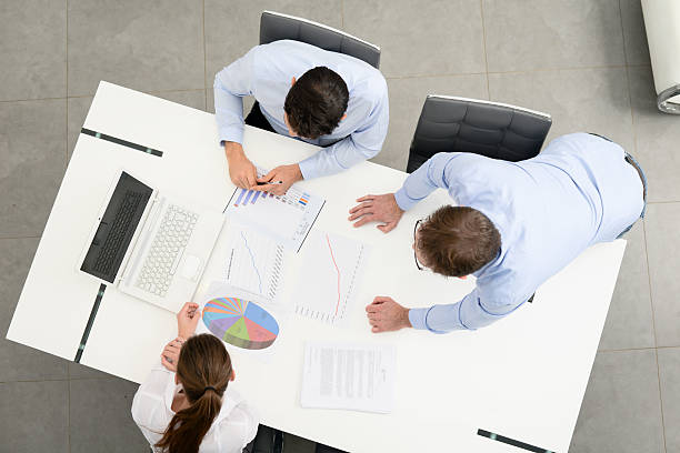 istock above view of business people working with computer in office 637813914