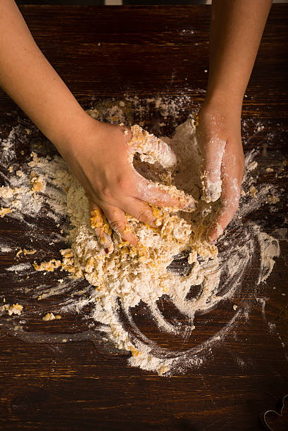 istock Preparing pastry for gingerbread. Kneading ingredients by hands. 637815604