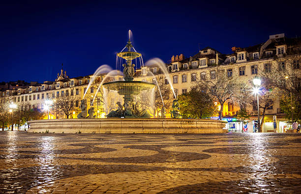 istock Fountain in Rossio square Lisbon at night time 637816812