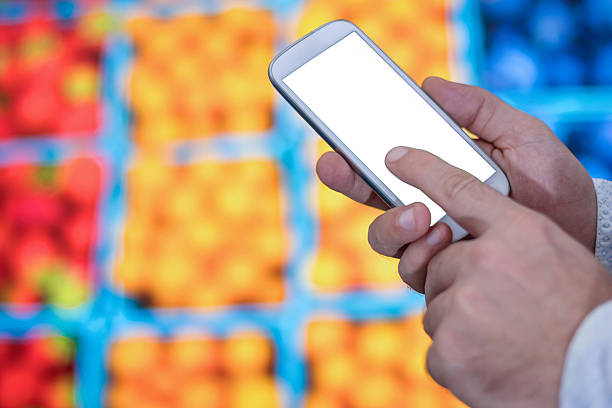 istock Man checking shopping list on her smartphone at supermarket. 637820736