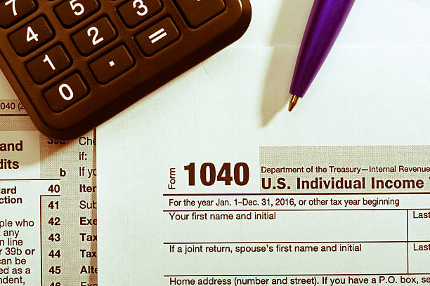 istock Pen and calculator on tax form 637821730