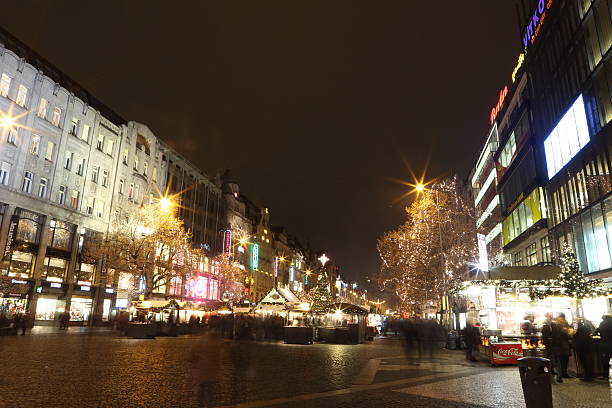 Prague, Czech Republic - December 30, 2016: Christmas market at Weceslas Square in Prague, capital of Czech Republic on the night of December 30th 2016, people from the country and tourists enjoy food and drinks at the fair,