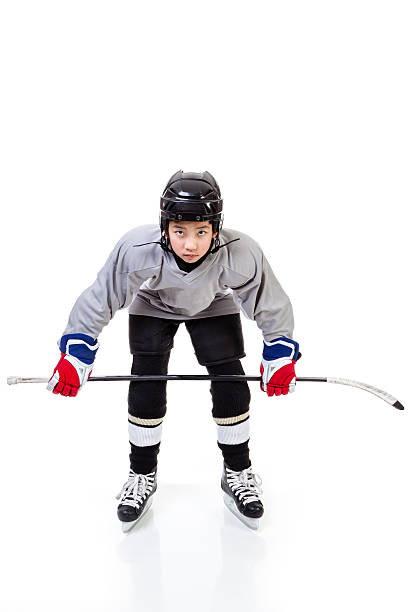 istock Junior Ice Hockey Player Isolated on White Background 637823760