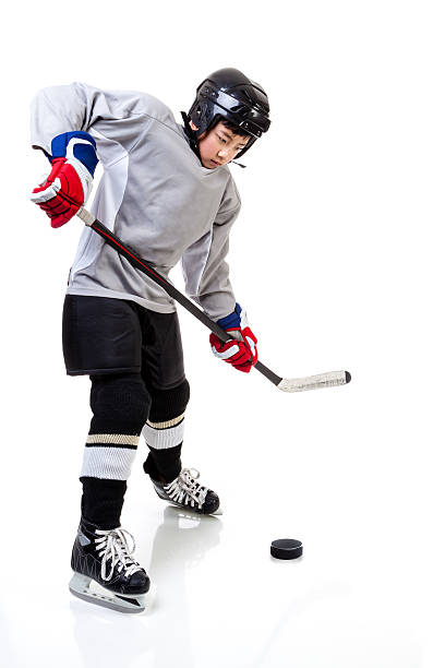 istock Junior Ice Hockey Player Isolated on White Background 637823840