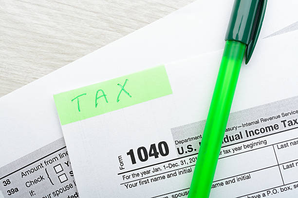 istock Green pen and sticker on tax form 637824110