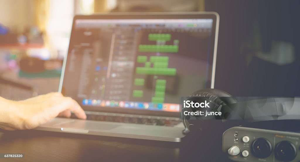 Electronic Musician is produce Music on his laptop. Music Stock Photo