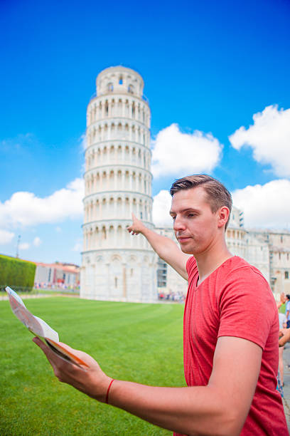 istock Young boy with toristic map on travel to Pisa. Tourist 637829002