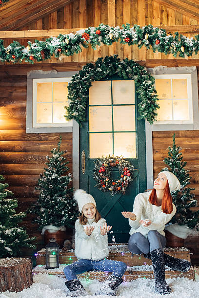 istock Mom and her daughter playing with snow 637833710