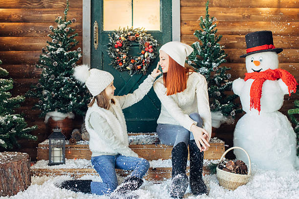 istock Mom and her daughter playing with snow 637833872
