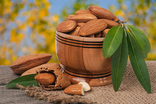 istock almonds in a bowl on the old wooden board with 637834090