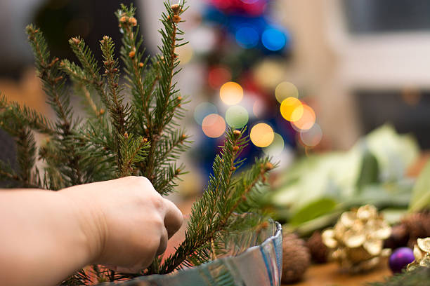istock Decorating Christmass bouqet  with red ornaments and tree branch 637835962