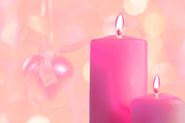 istock Pink burning candles on a blurred festive background 637836508