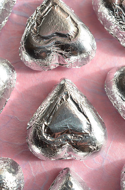istock silver foil wrapped chocolate heart candy pink paper 637836686