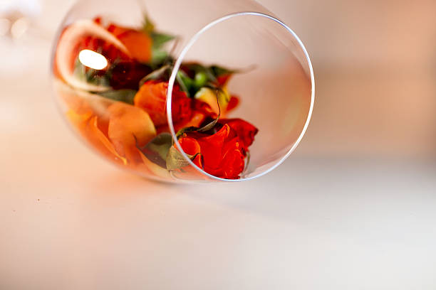 istock Glass vase filled with red rose petals. Aromatherapy concept. 637837512