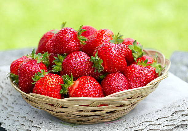 istock basket with strawberries on a garden wooden table 637838272