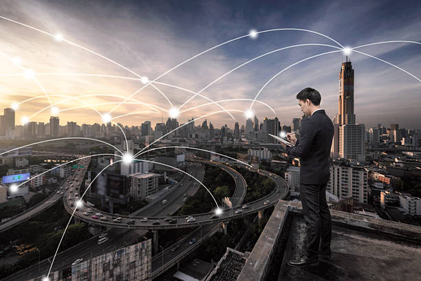 istock Business man standing over cityscape with connetion technology l 637845382