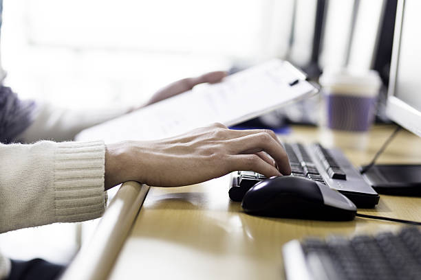 istock young asian man with pc and clipboard 637845754