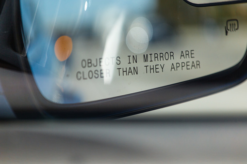 Objects in mirror are closer than they appear on car