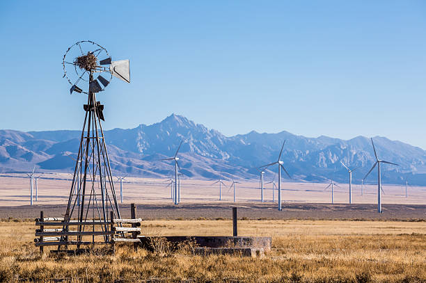 istock Old windmill in front of big new wind farm 637849370