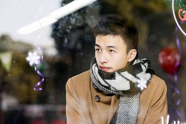 young asian man has a break in cafe