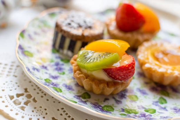 istock Small fruit tarts laid out on an antique china plate 637850456